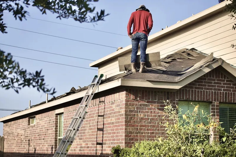 Professional roofer working on a residential roof in Charleston